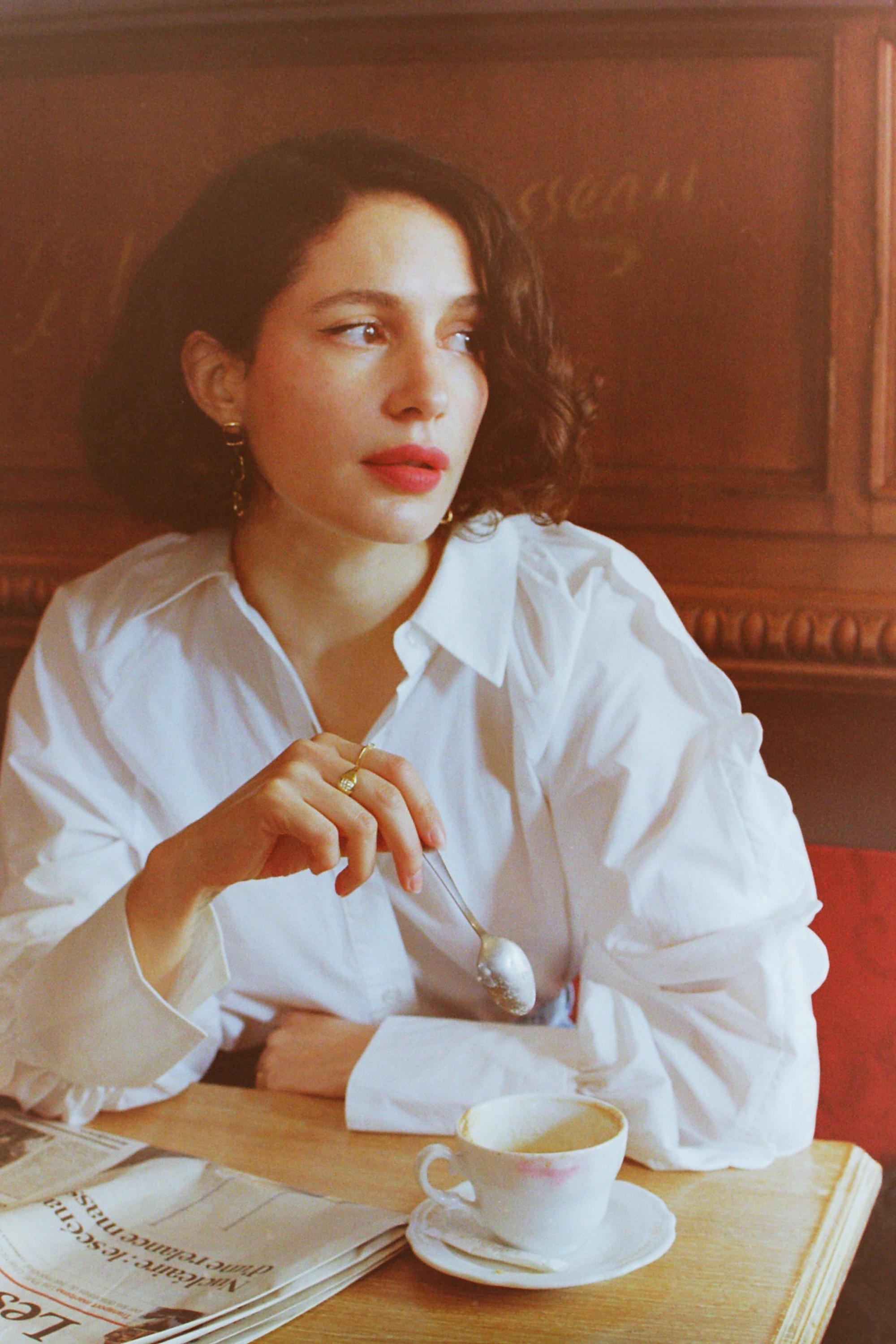 portrait of a woman in a Parisian cafe captured on analog film by Anya Parsley