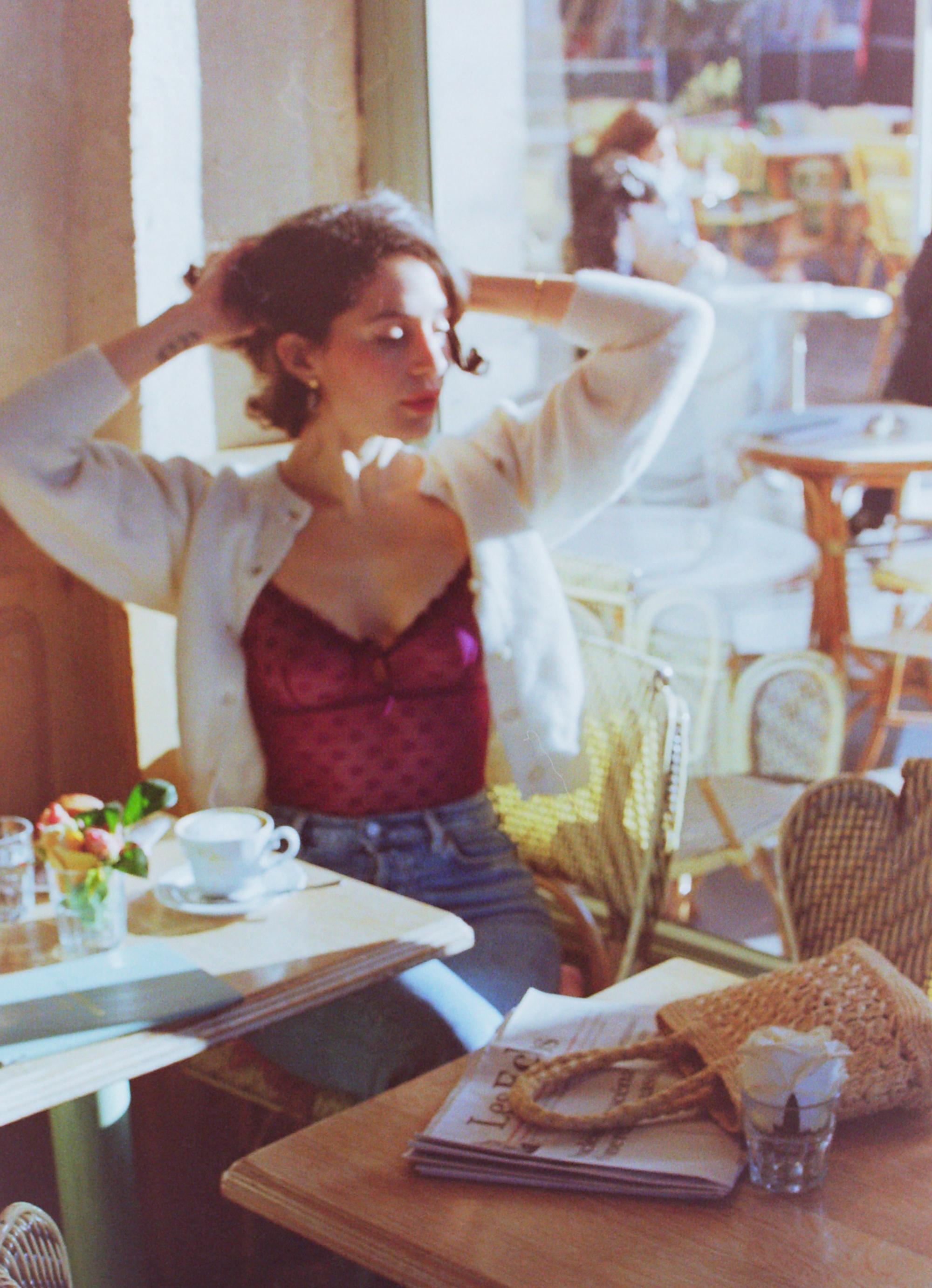 analog photo of a woman in a Parisian cafe