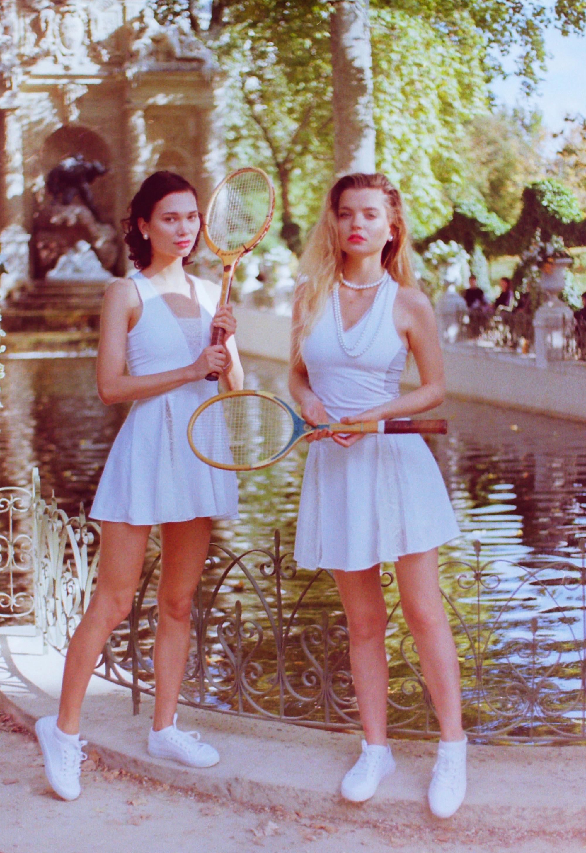 Thaber campaign shoot featuring blond and brunette models in vintage tennis attire, holding vintage tennis rackets, shot on film by Paris fashion photographer Anya Parsley