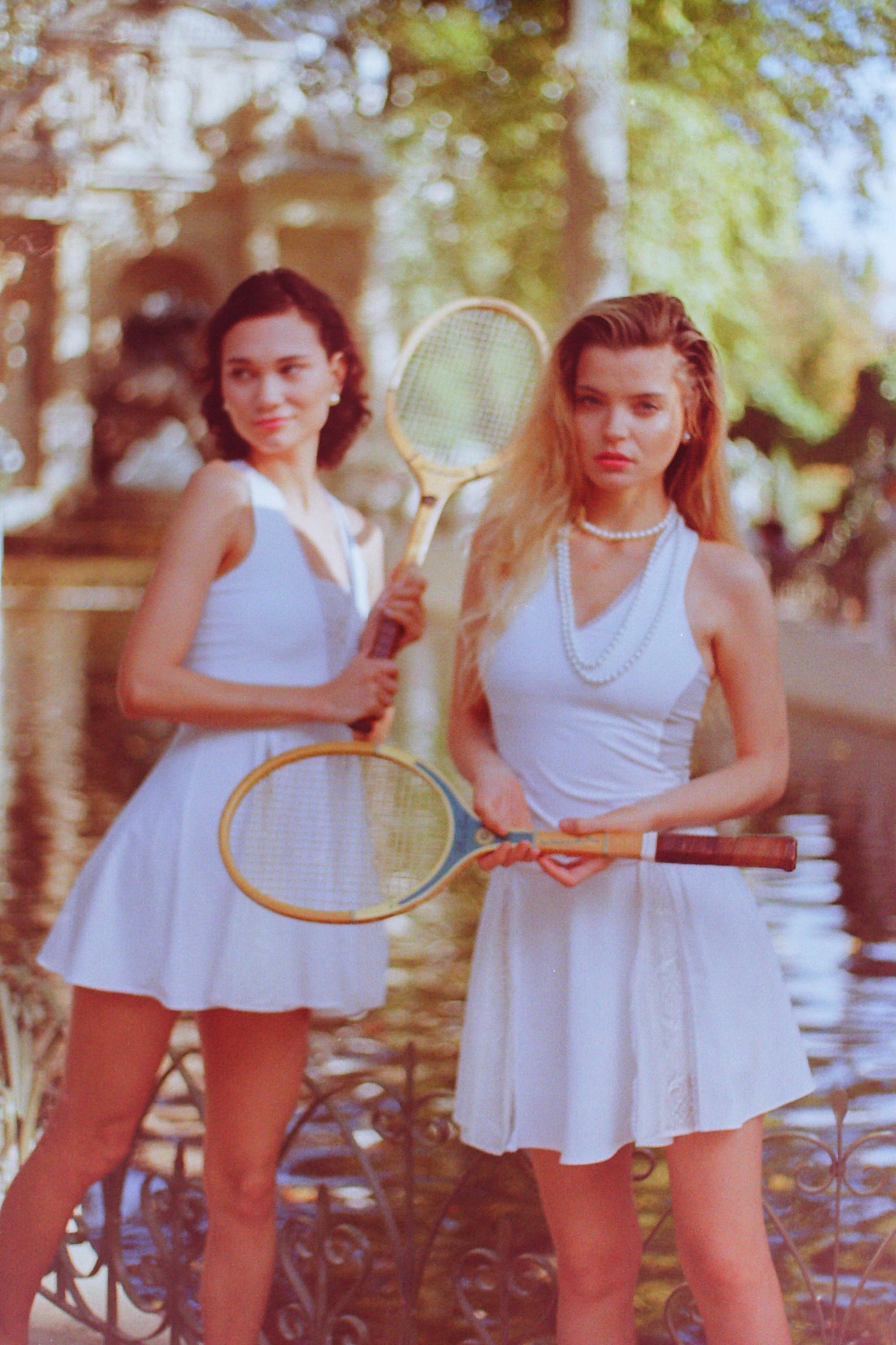 Thaber campaign shoot featuring models in retro tennis attire holding vintage tennis rackets, captured on film by Paris fashion photographer Anya Parsley