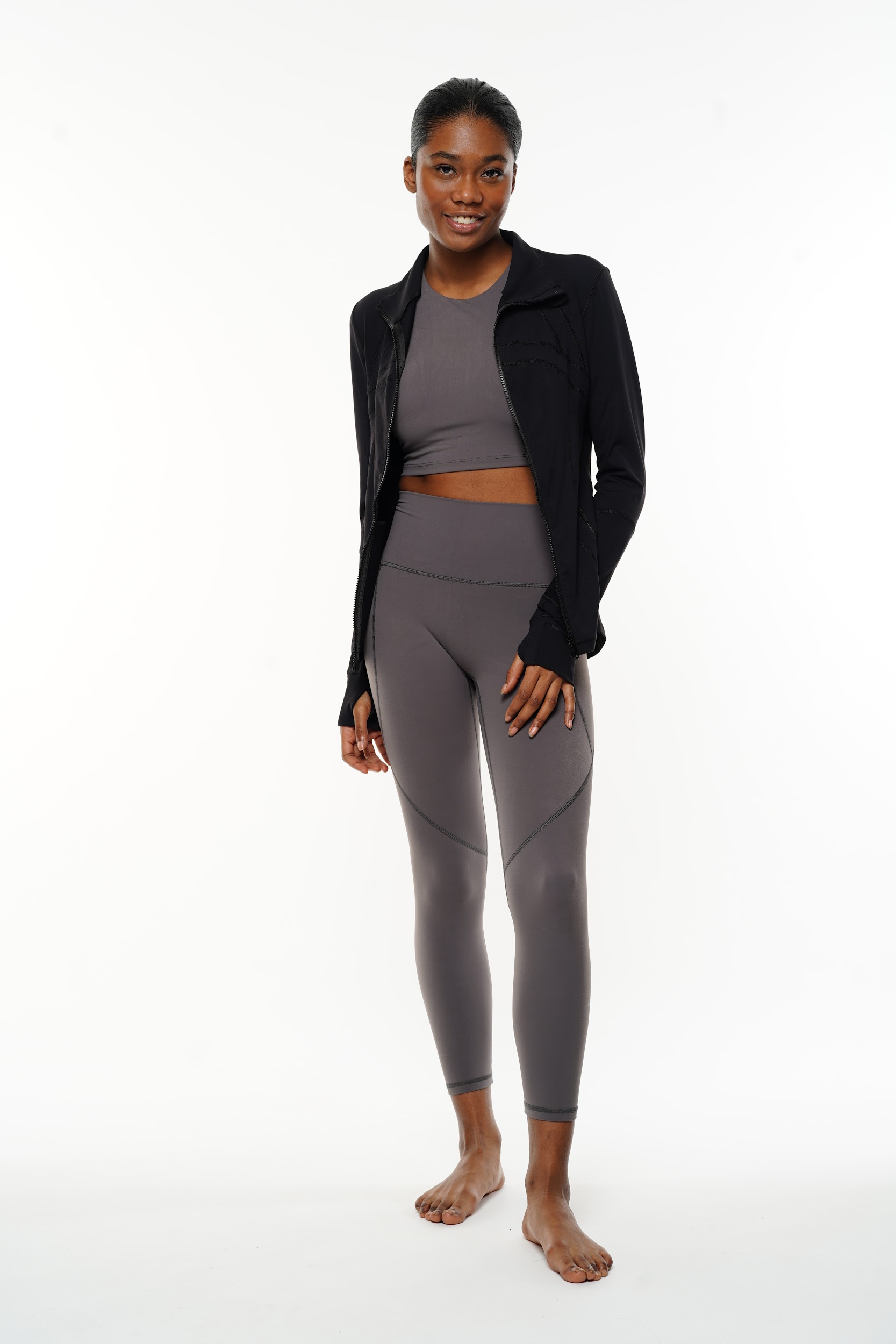 Female model posing in breathable sportswear during Paris studio shoot.