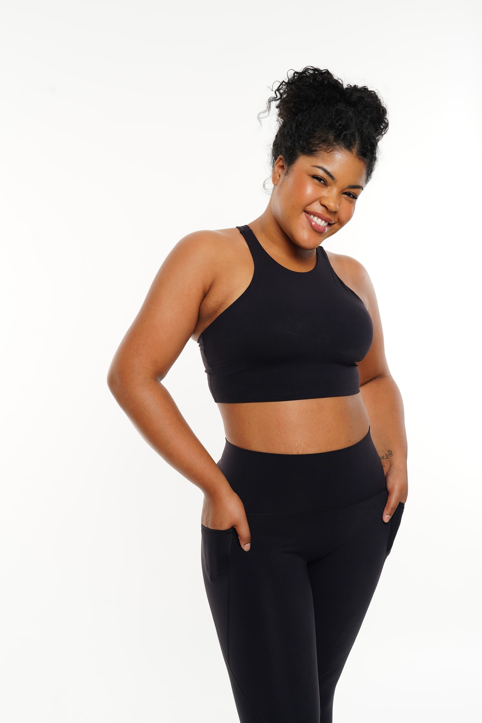 Plus-size model posing in breathable sportswear during Paris studio shoot by Anya Parsley