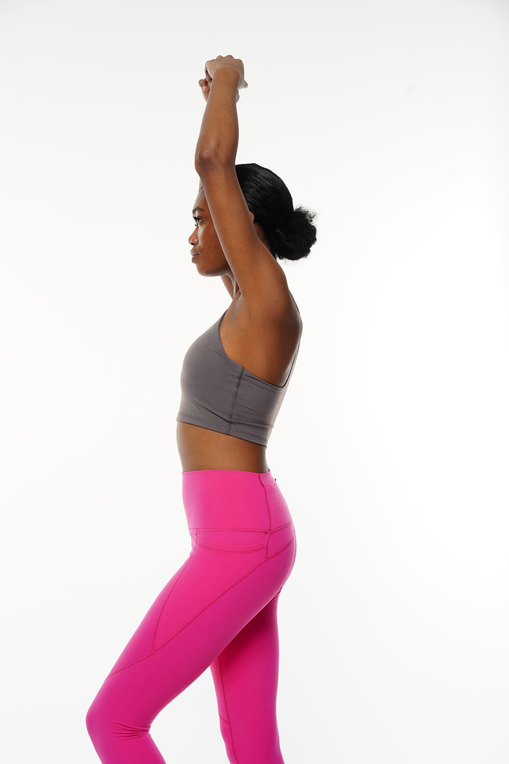 Model in yoga outfit demonstrating flexibility on a white backdrop in the Paris photo studio