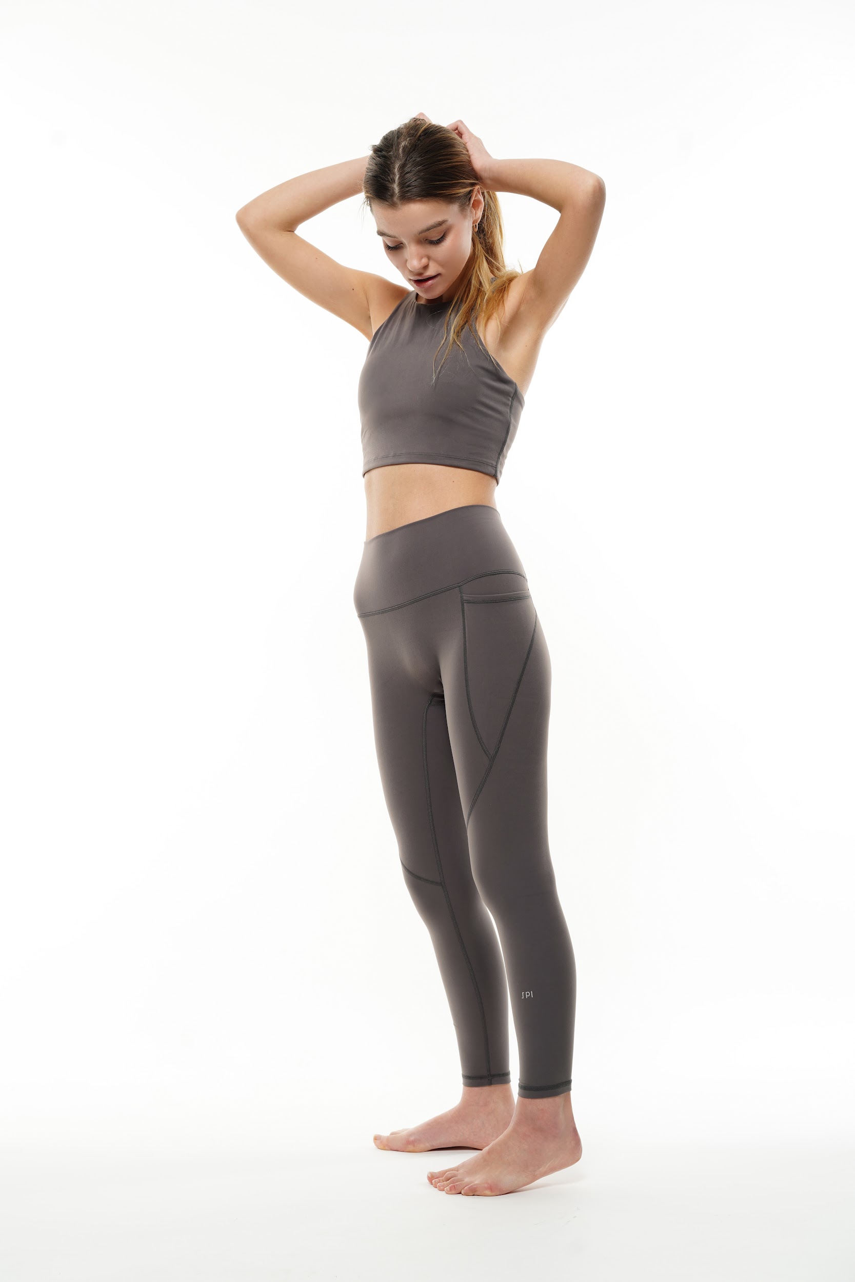 Studio shot of a model in a matching sports bra and leggings set by fashion photographer Anya Parsley