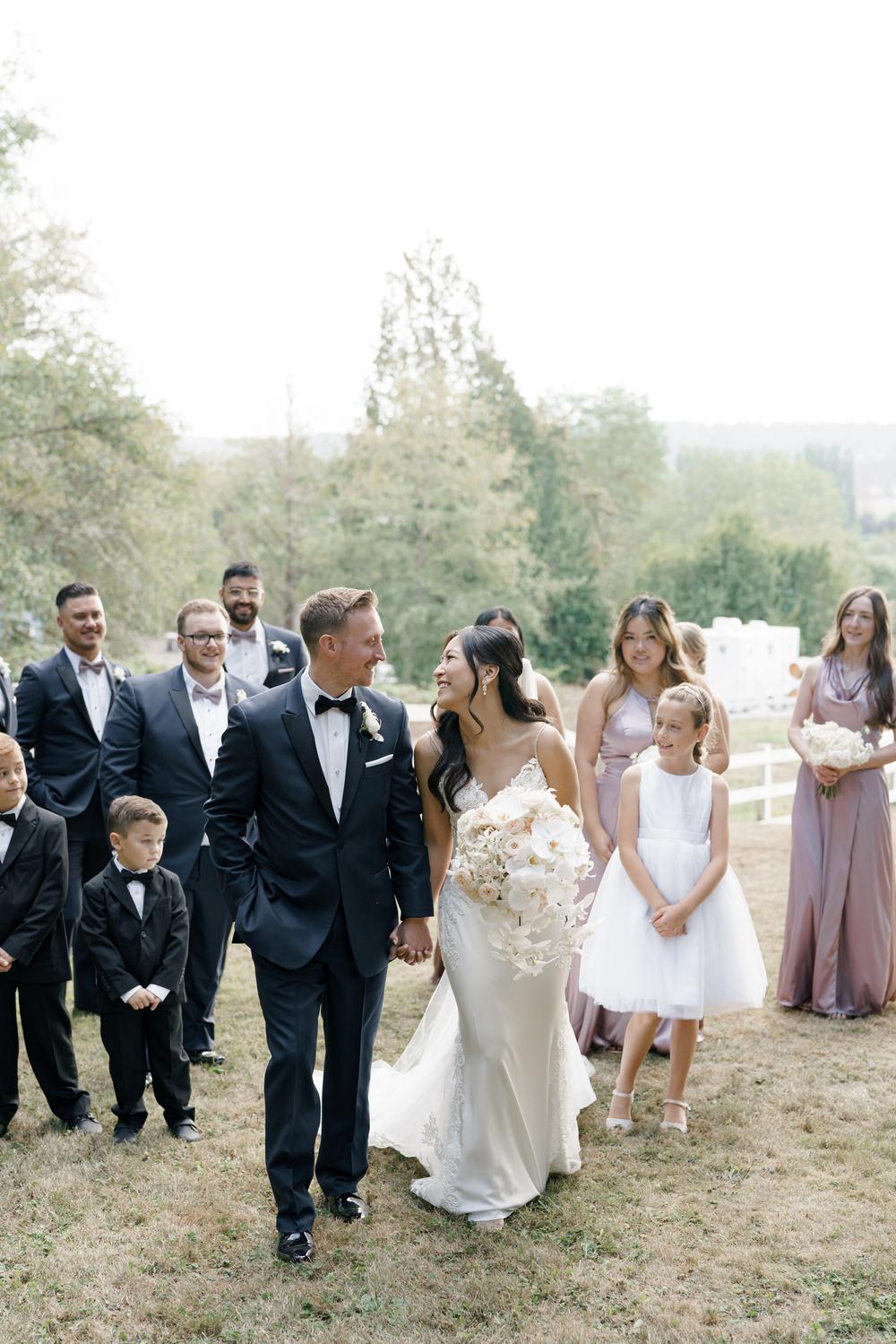 Bride and groom walking with their wedding party