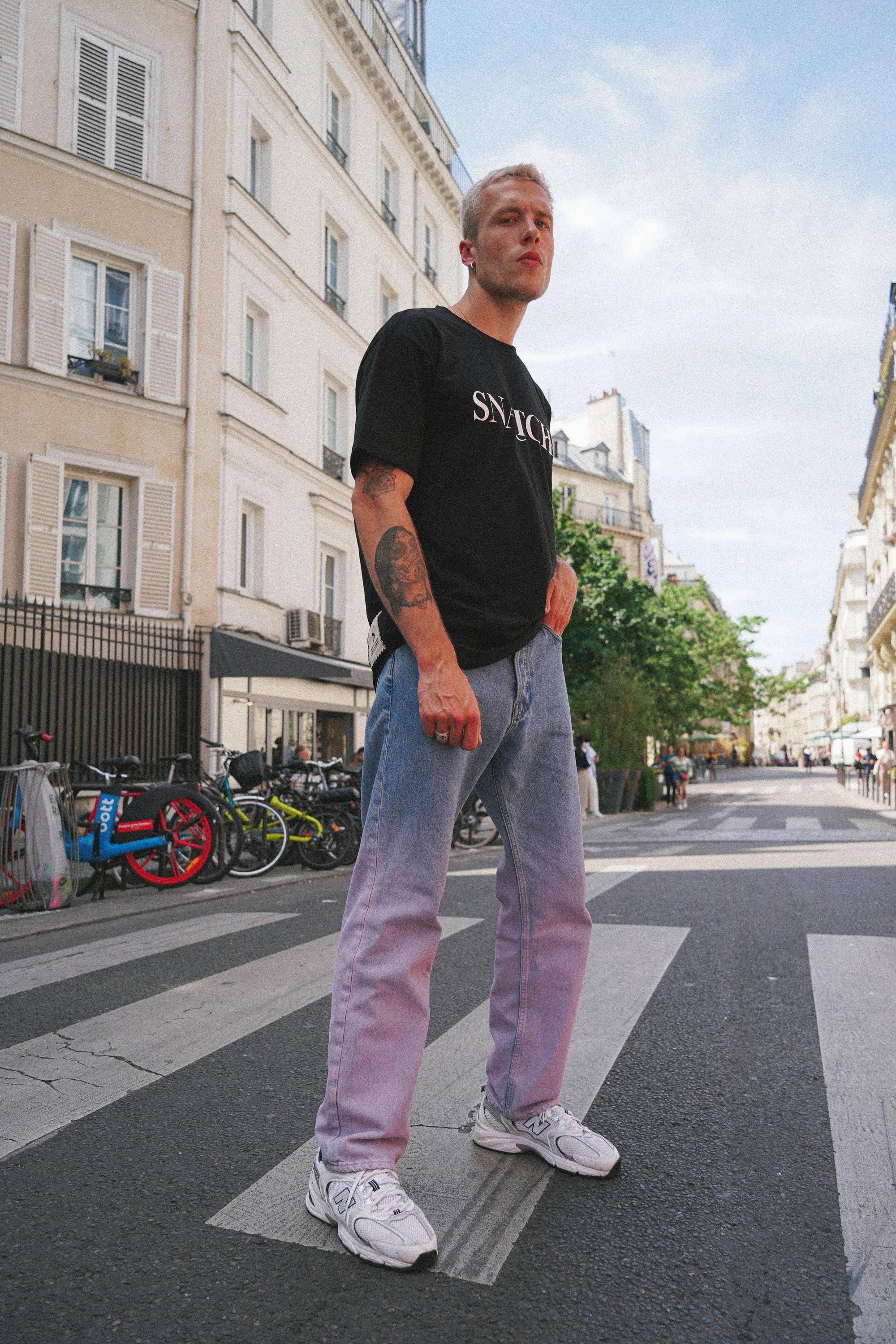 Street style apparel featuring bold design elements in urban environment captured by Paris fashion photographer
