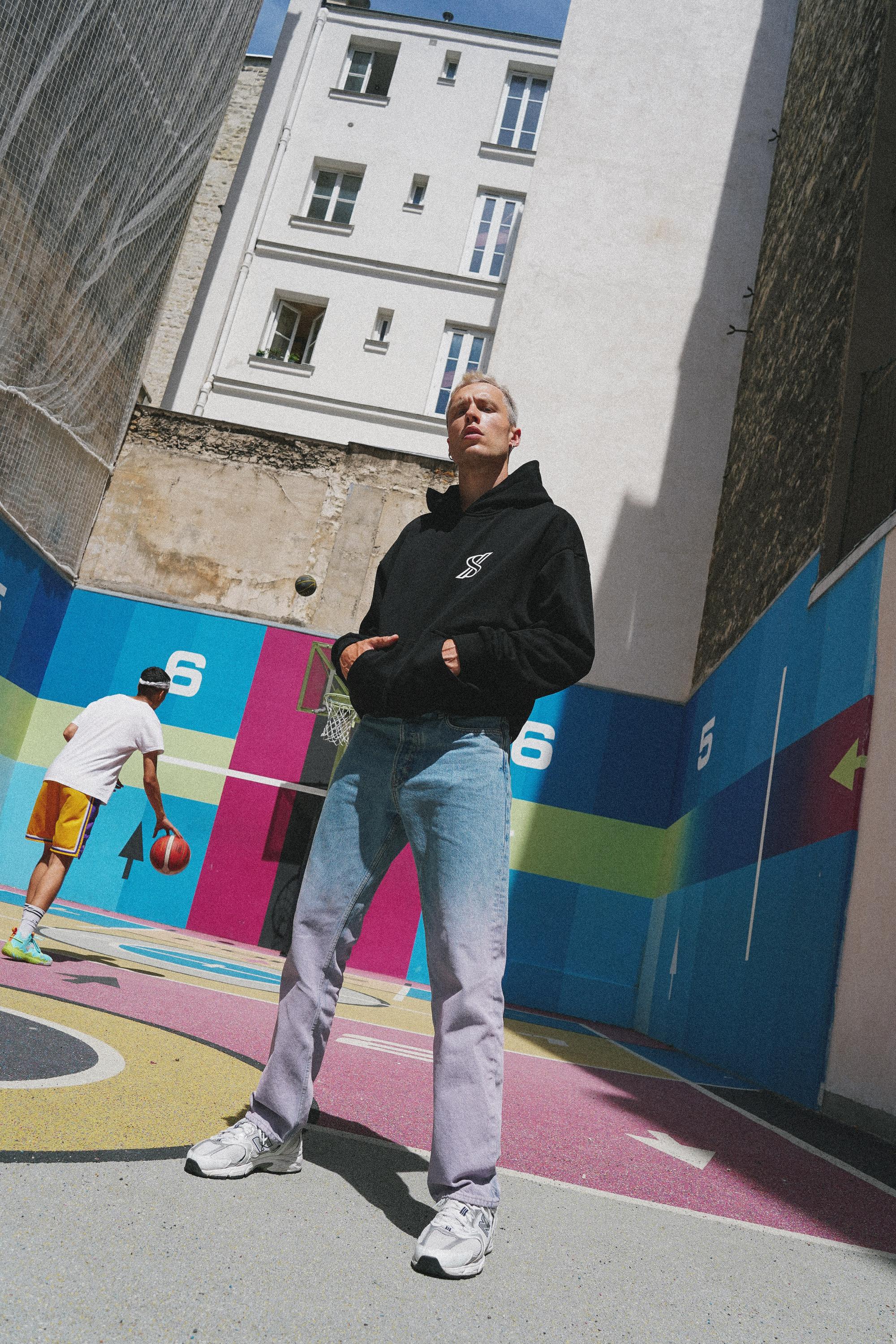 Male model wearing SNATCH t-shirt at Duperré basketball court in Pigalle by Paris street style fashion photographer