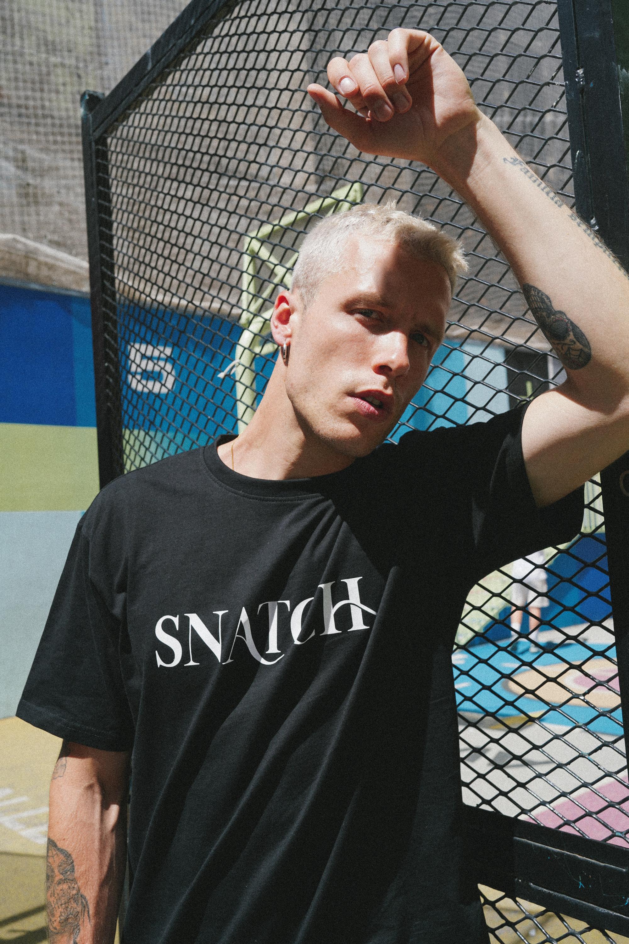 Close-up of SNATCH logo on t-shirt during street style Paris shoot