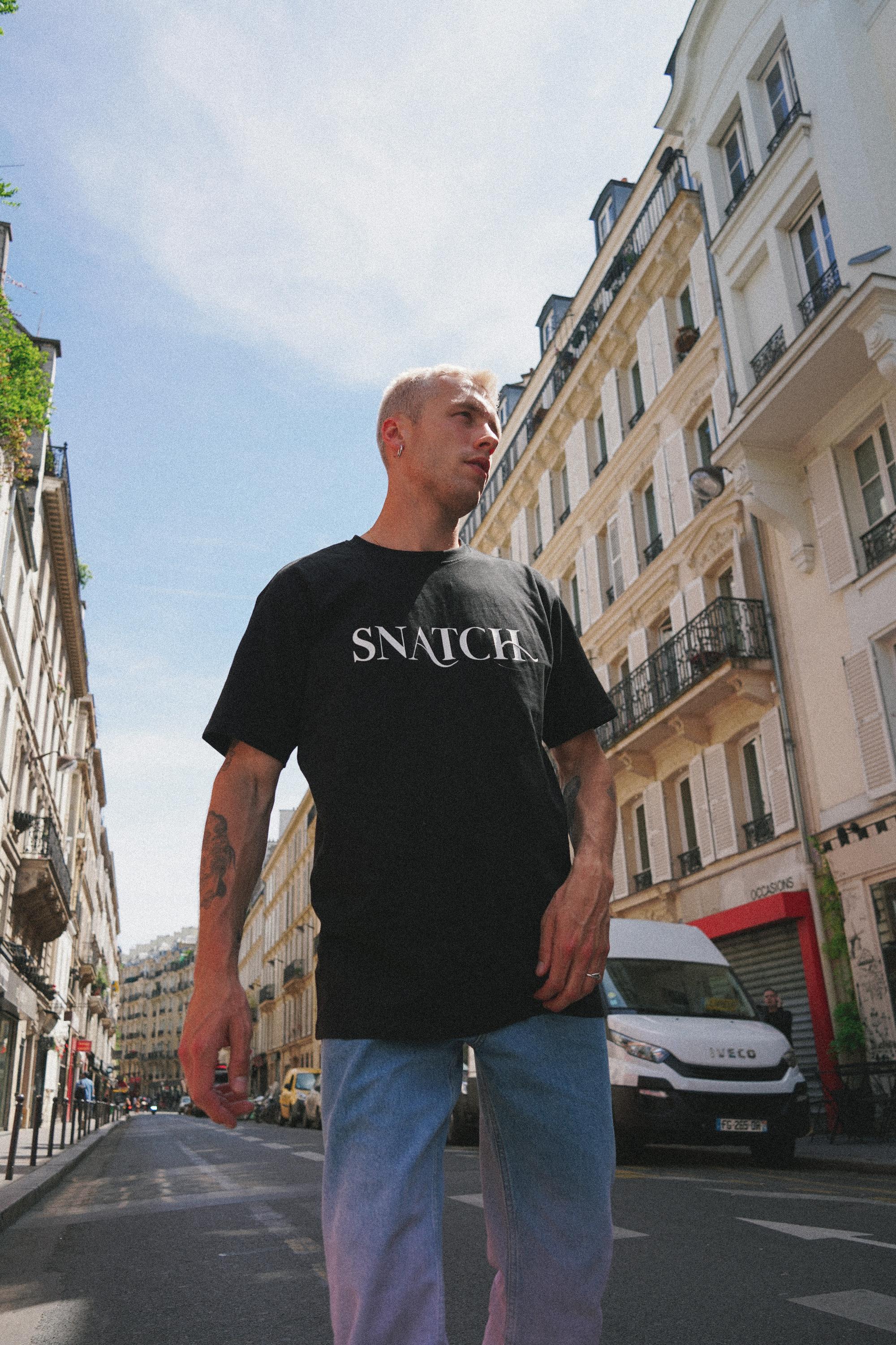 SNATCH apparel featuring bold design elements in urban environment captured by Paris fashion photographer
