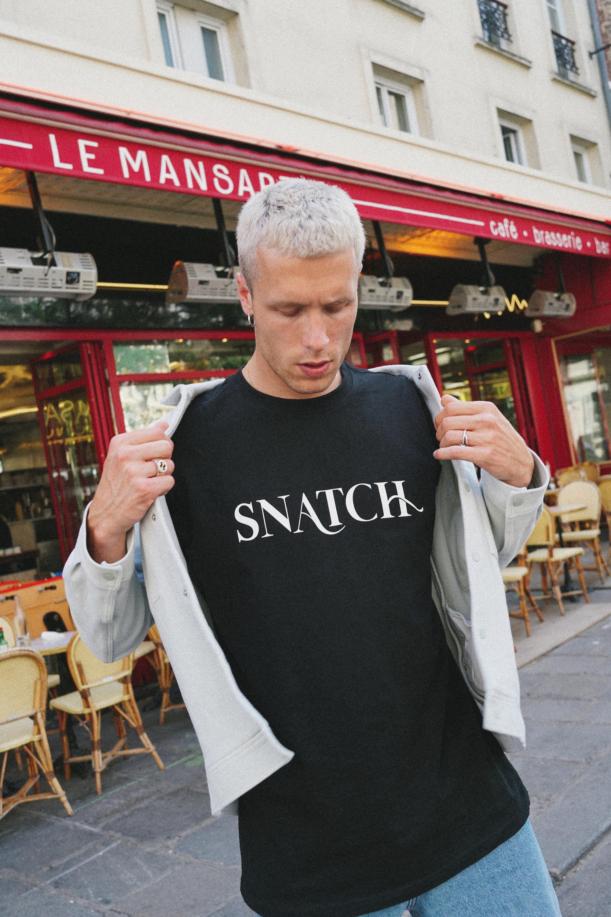 SNATCH apparel featuring bold design elements in urban environment captured by Paris fashion photographer