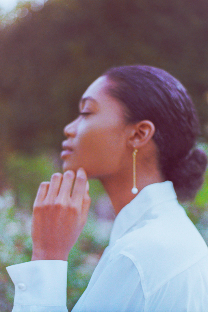 Gina Gant Pearls jewelry displayed against lush garden backdrop, highlighting natural elegance in fashion photography on film