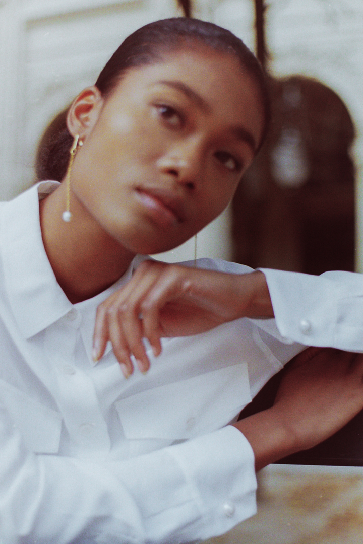 Serene model wearing Gina Gant Pearls jewelry, photographed by film fashion photographer in Paris for timeless appeal