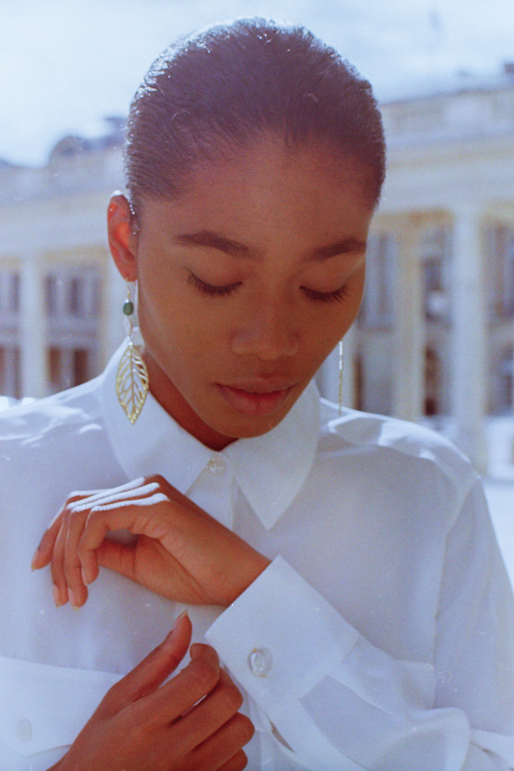 photo of a model adjusting pearl cufflinks during a jewellery lookbook photoshoot in Paris