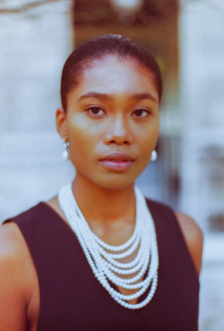 Artistic composition of Gina Gant Pearls earrings and necklace on model, showcasing brand's aesthetics in a lookbook in Paris shot on film