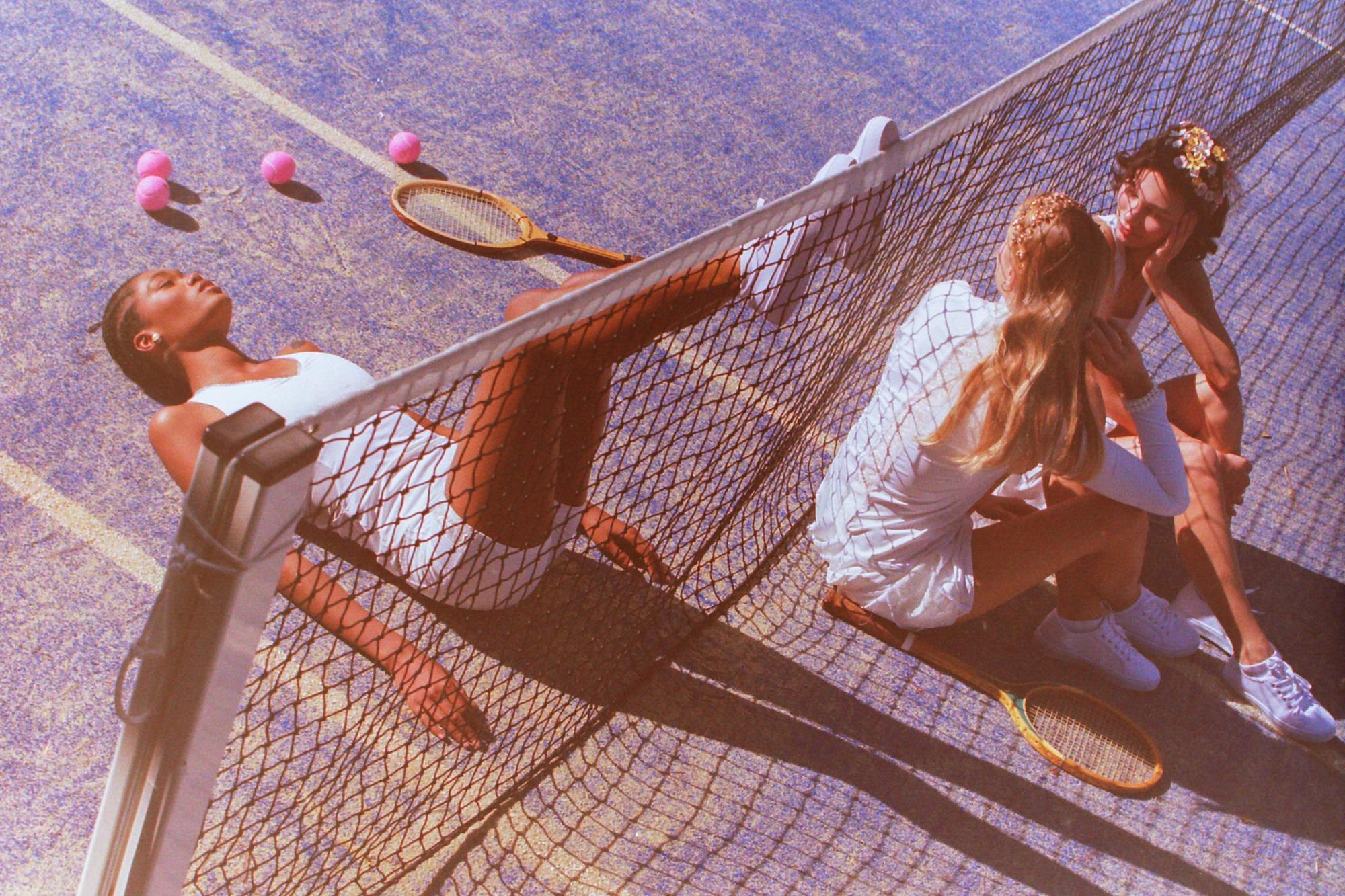 Thaber campaign shot on film at a blue tennis court, featuring diverse models in stylish tennis attire, photographed by Anya Parsley, Paris fashion photographer