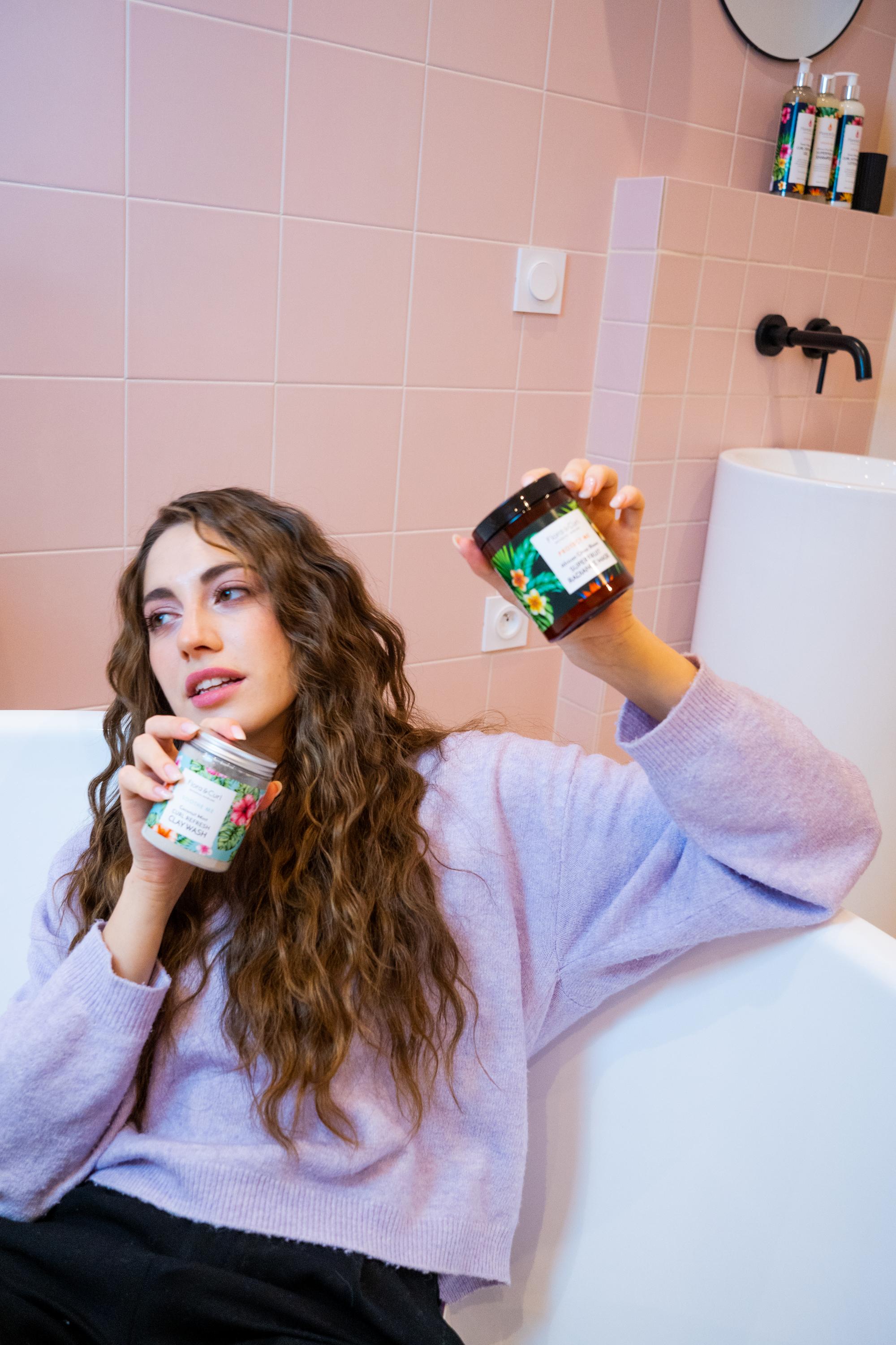 Model showing curly hair care products during commercial photoshoot by Paris fashion photographer Anya Parsley
