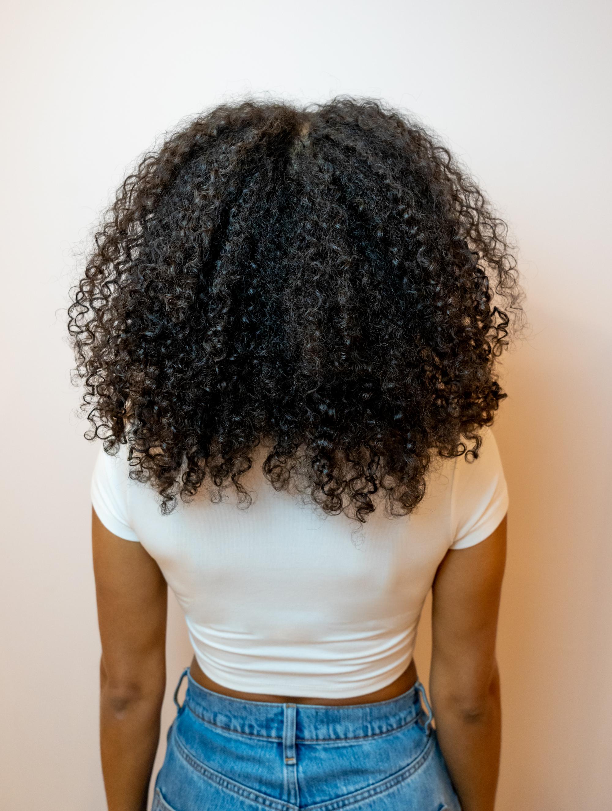 Before-and-after shots of curly hair transformation by Paris fashion photographer