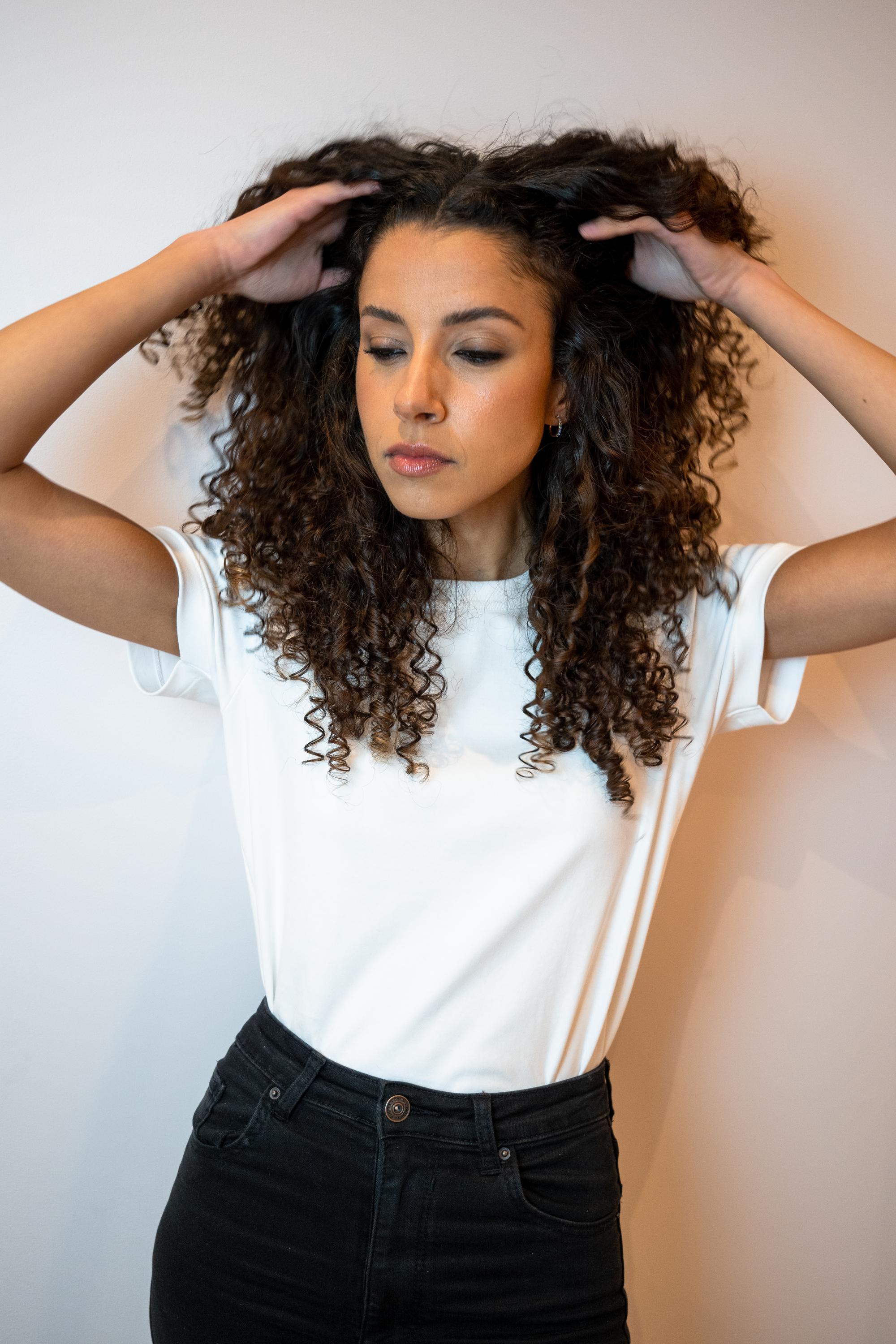 Close-up of curly hair transformation during Paris commercial photoshoot.