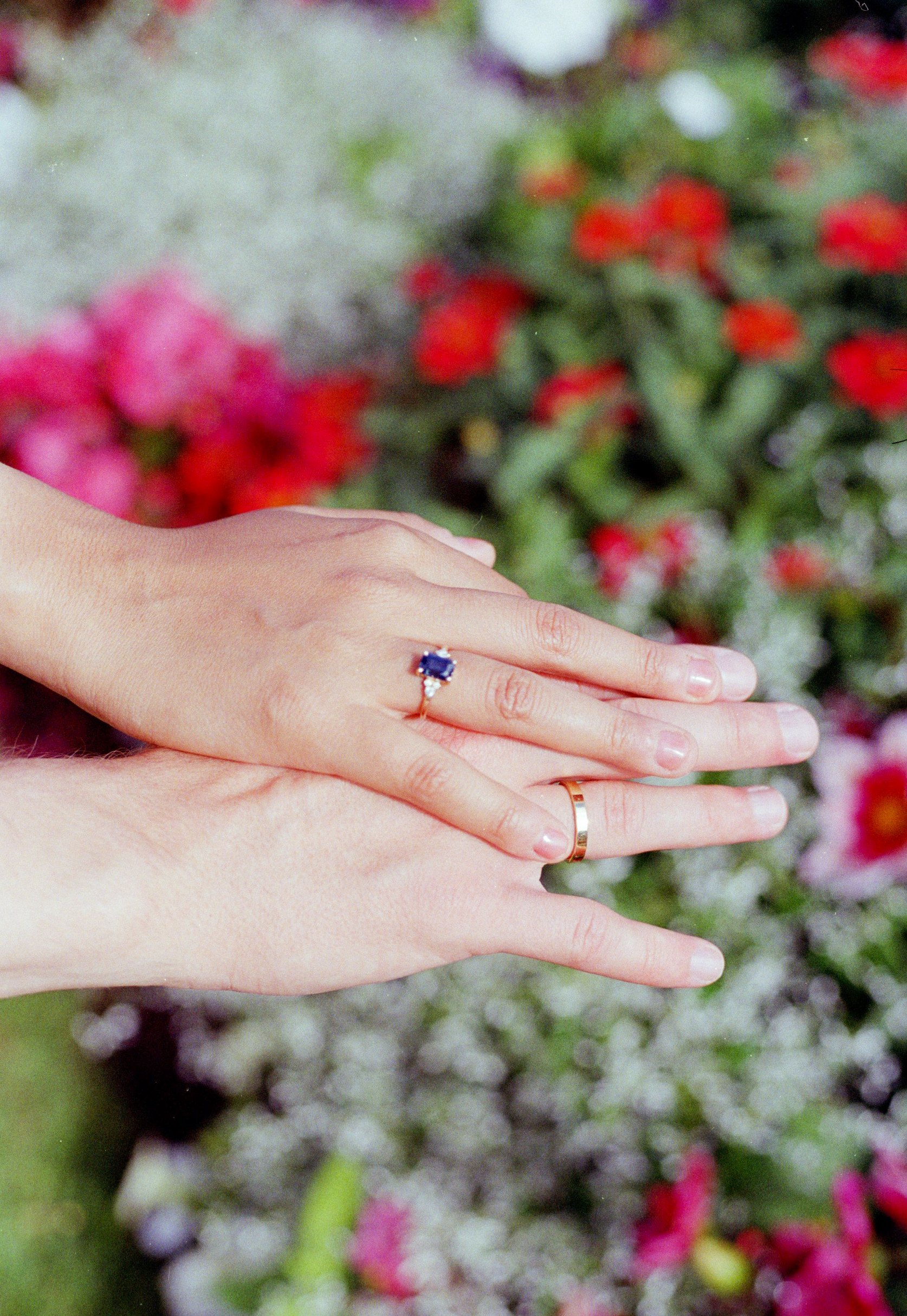couple's hands with engagement rings captured by engagement photographer in Paris