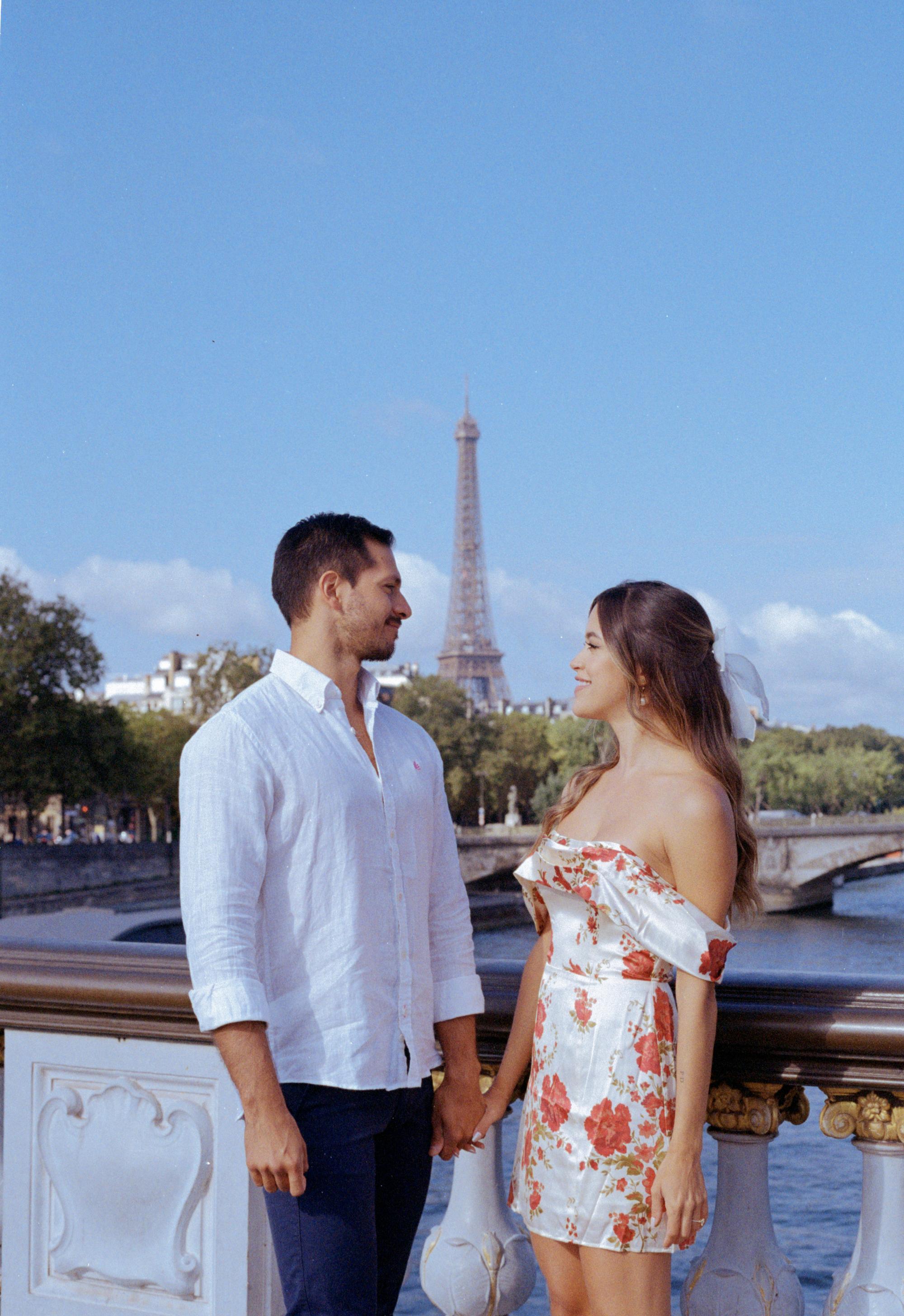 couple looking at each other during their engagement photo shoot in Paris