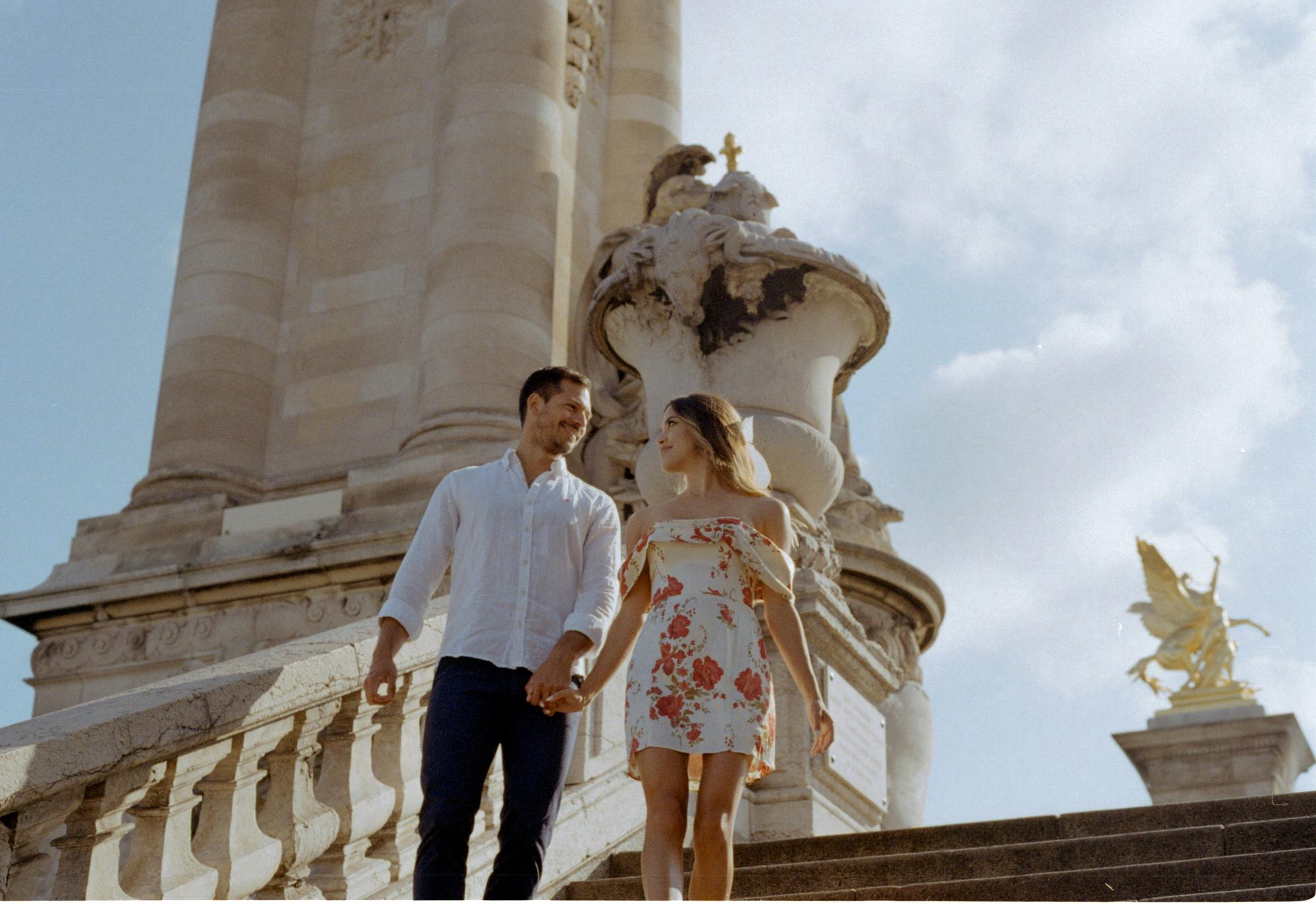 couple walking the stairs of the bridge Alexandre III - majestic engagement photo session in Paris